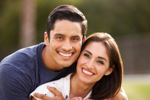 istock Young Hispanic couple looking to camera smiling, close up 1094439640