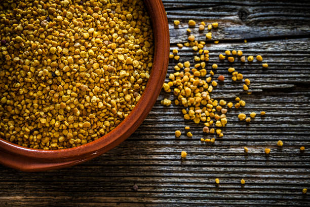 istock Bee pollen in a brown clay bowl shot from above on rustic wooden table 1094442940