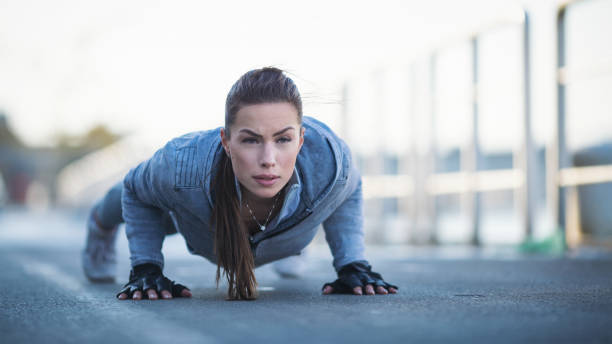 istock Young woman exercising outdoors 1094443330