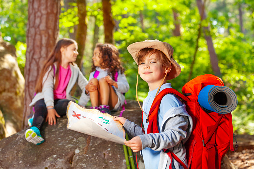 Group family children checking map in the jungle adventure.   Asia people tourism for destination leisure trips for education and relax in nature park.  Mountain background.  Travel vacations and Life Concept