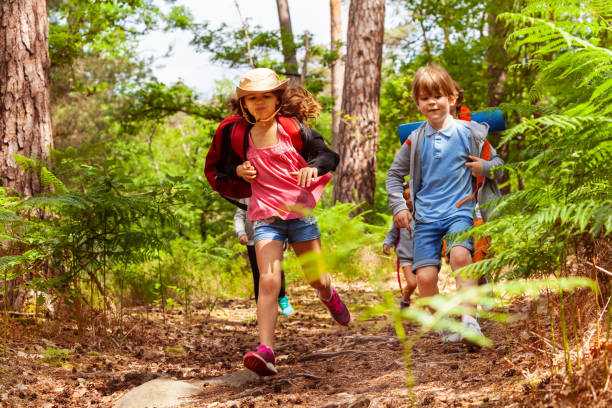 istock Boy and girl running in the forest 1094444772