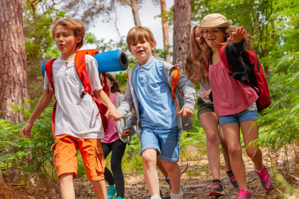istock Kids running in the forest together holding hands 1094444788