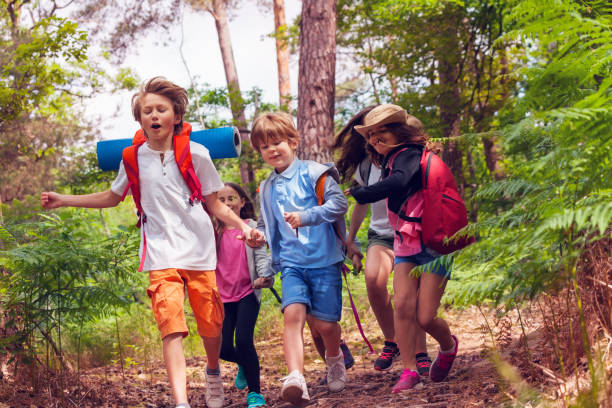 istock Group of kids run fast in forest trail 1094444802