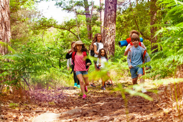 istock Kids running in the forest on school trip activity 1094444820
