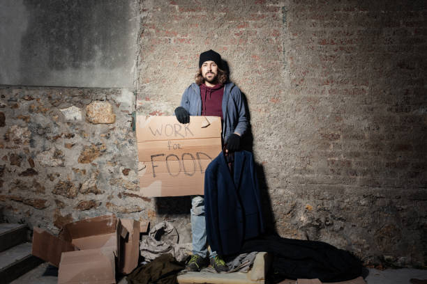 istock Jobless man looking for job with cardboard sign 1094446936