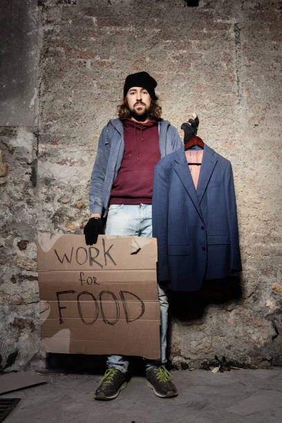 istock Jobless man with cardboard Work for food sign 1094446958