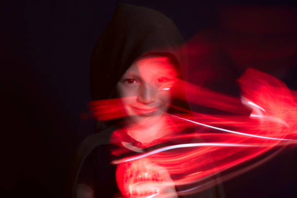 istock boy portrait in dark  with red light effects on black background 1094448526