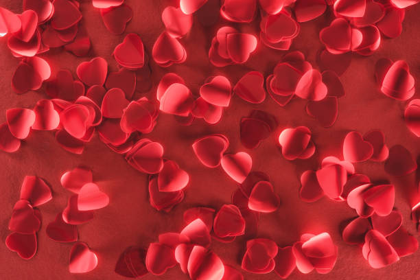 istock beautiful decorative heart shaped petals on red background, valentines day concept 1094448554