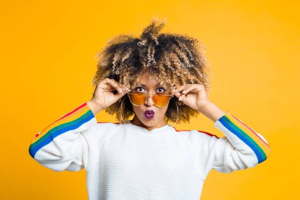 istock Funky afro girl against yellow background 1094449850