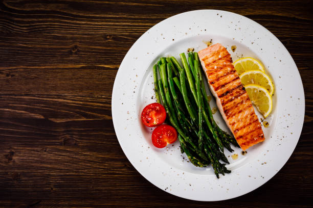 istock Grilled salmon with asparagus and arugula on wooden table 1094450192