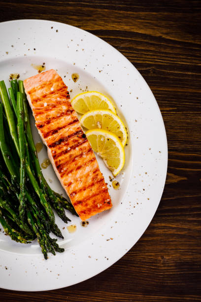istock Grilled salmon with asparagus and arugula on wooden table 1094450428