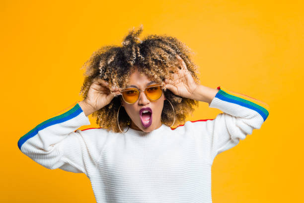 istock Funky afro girl against yellow background 1094450444