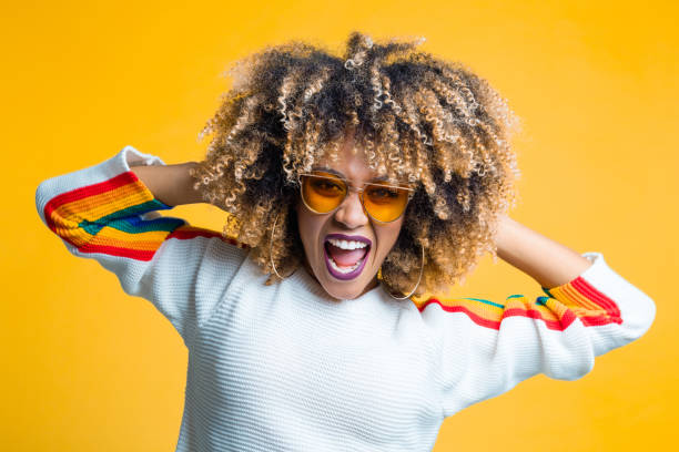 istock Funky afro young woman against yellow background 1094450730