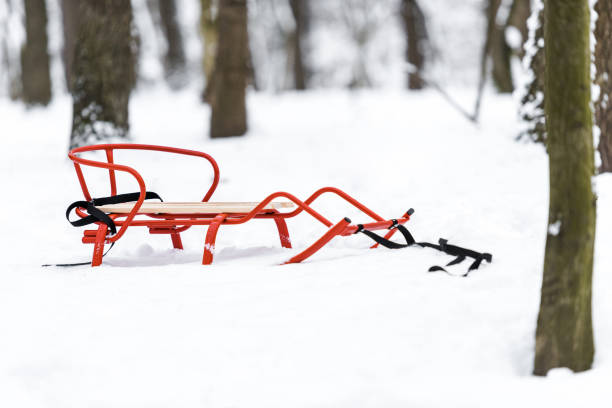 istock red metal sledge on snow in winter park 1094453734