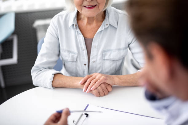 istock Close up of aged woman putting hand on the table while visiting practitioner 1094457292