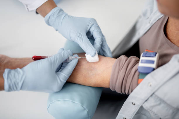 istock Arm on cushion and doctor taking blood sample 1094457466