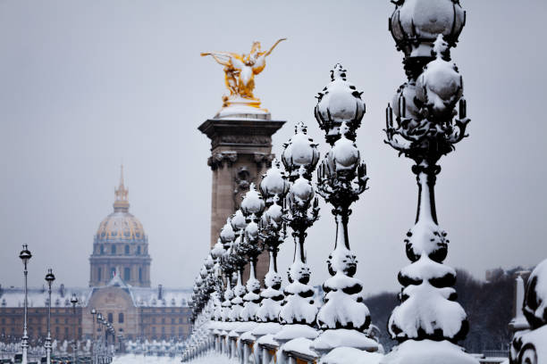 istock Pont Alexandre III and Invalides cathedral in snow 1094461732