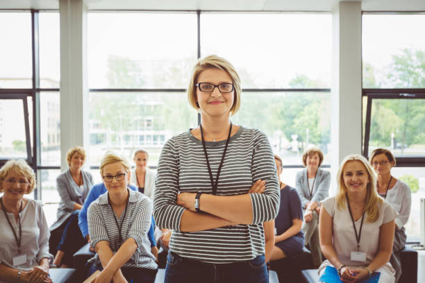 istock Happy mature female presenter at seminar 1094461860