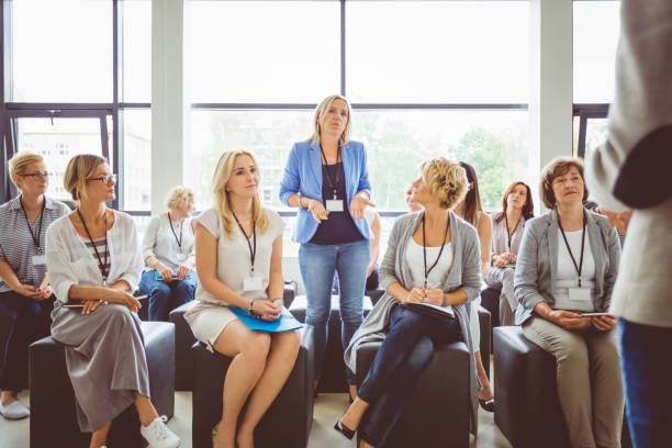 Interactive question and answer session during seminar One of woman asking a question to speaker during conference. Group of business women attending a lecture. woman press conference stock pictures, royalty-free photos & images