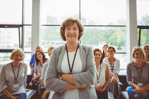 istock Smiling mature female speaker at seminar 1094462830