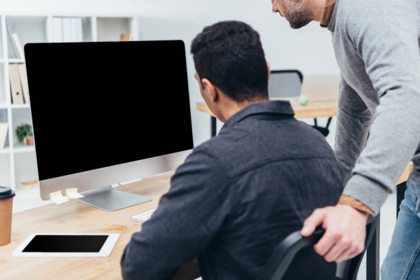 istock cropped shot of business colleagues using desktop computer with blank screen in office 1094462868