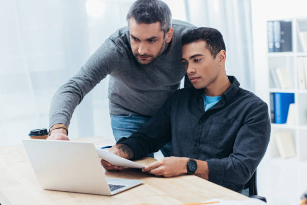 istock two focused businessmen working with papers and laptop in office 1094462984