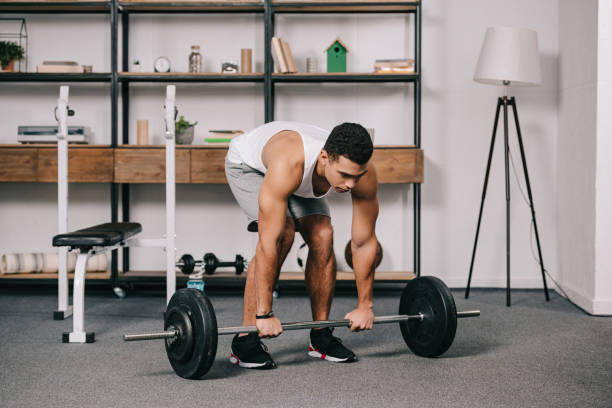 istock handsome bi-racial man workout in home gym 1094468672