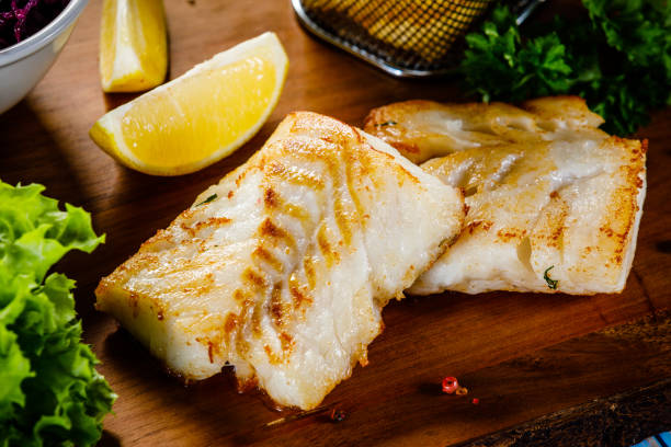 istock Fried cod fillet with French fries and vegetables 1094469240