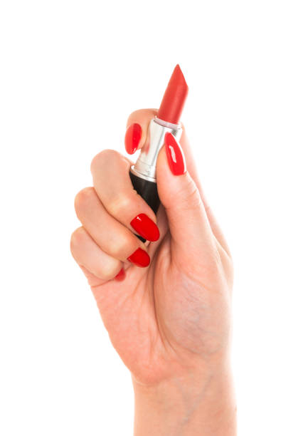 istock Woman Hand With Red Nails Holding Lipstick 1094469408