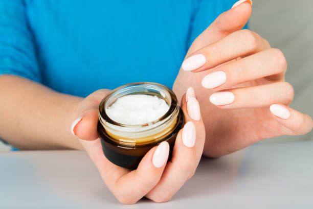 istock beautiful woman hands with cream 1094469432
