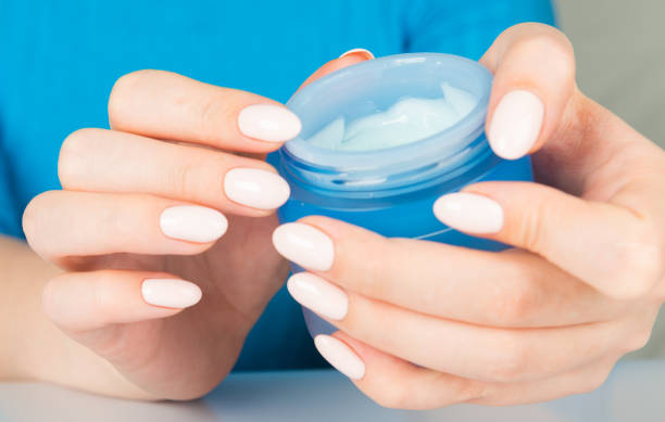 istock beautiful woman hands with cream 1094469442