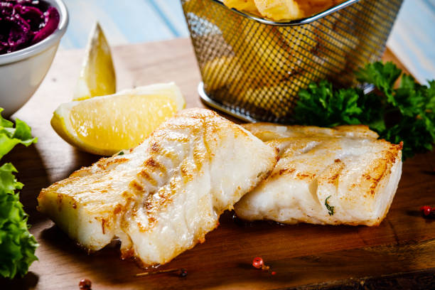 istock Fried cod fillet with French fries and vegetables 1094469906