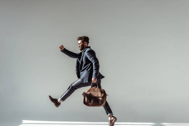 istock bearded man with brown bag jumping on grey background 1094470018