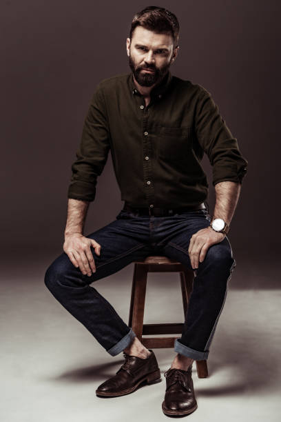 istock handsome bearded man in brown shirt looking at camera 1094470216
