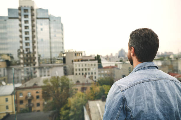 istock Man is standing outdoor and looking on city 1094470286