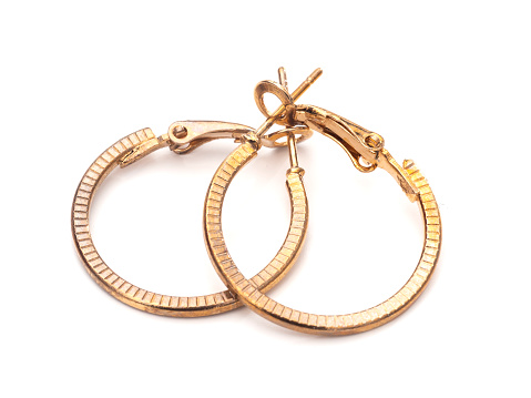 Old gold colour hoop earrings, pair, on white background.