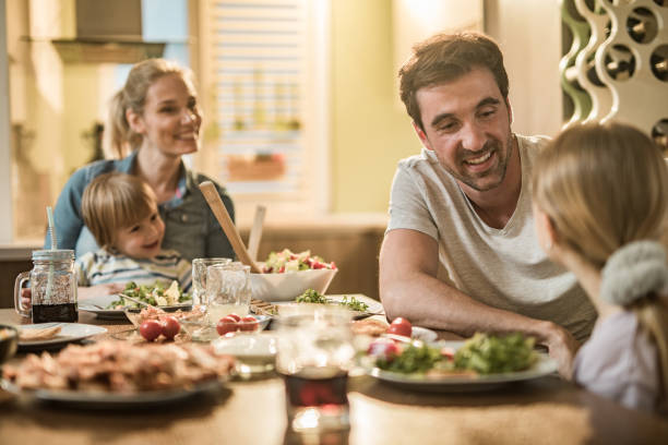 istock Happy family communicating during lunch time in dining room. 1094473286