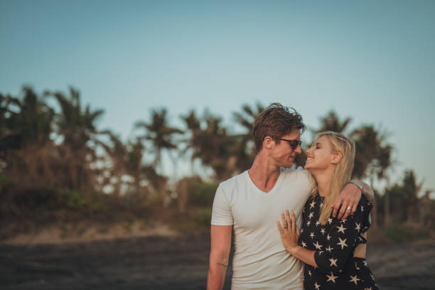 istock Young couple taking a walk on the beach 1094475636