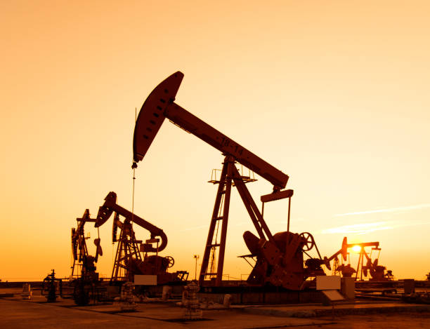 istock Oil pumps and rig at sunset 1094476286