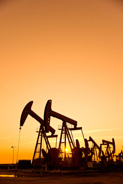 istock Oil pumps and rig at sunset 1094476346
