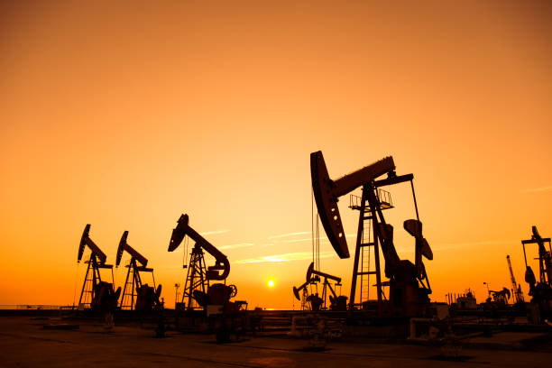 istock Oil pumps and rig at sunset 1094476502