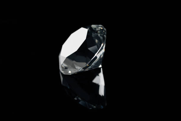 istock pure shiny diamond with reflection isolated on black 1094477114