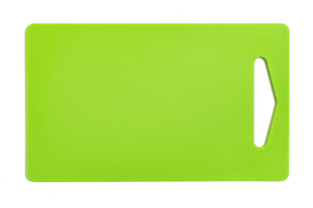 Green plastic cutting board isolated on white background. Top view stock photo