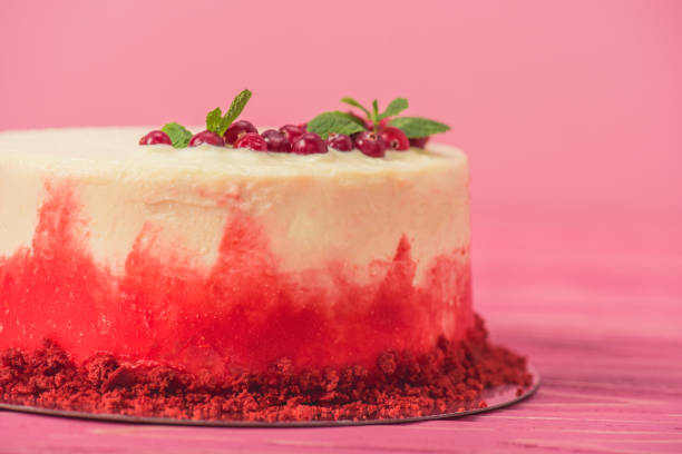 istock white cake with decorated with red currants and mint leaves isolated on pink 1094479100