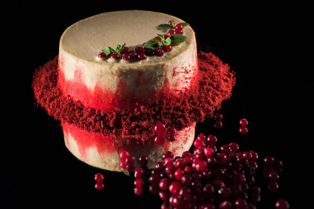 istock white cake decorated with mint leaves near currants isolated on black 1094479182