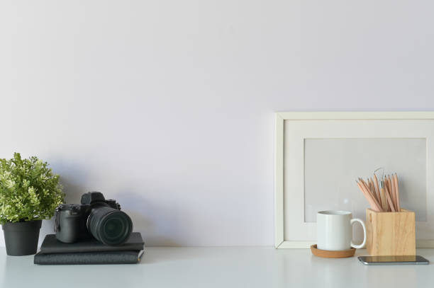 istock Photographer desk concept. designers table, photo camera, notebook paper, coffee and photo frame Copy space, background. - Image. 1094482964