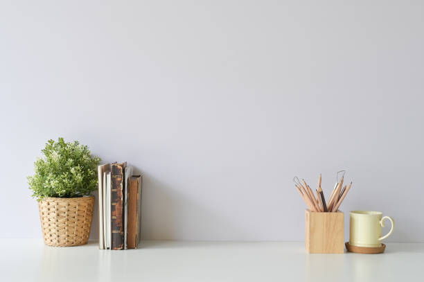 istock Workspace with books, coffee, pencil and plant decoration on office white desk. 1094484352