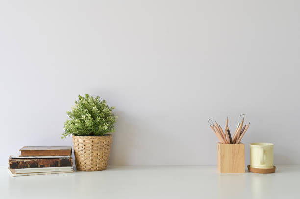 istock Workspace with books, coffee, pencil and plant decoration on office white desk. 1094484410