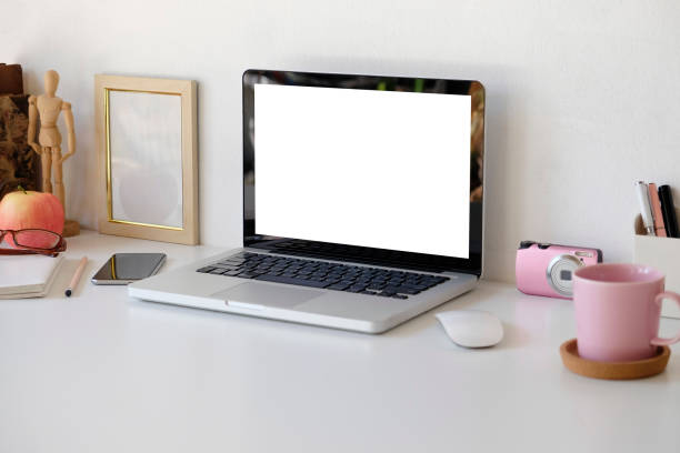 istock Female workspace, laptop computer, camera, pen, flower with mug of coffee on office desk. 1094485586