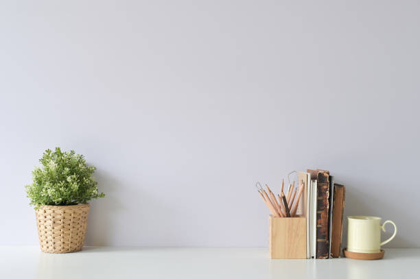 istock Workspace with books, coffee, pencil and plant decoration on office white desk. 1094487924